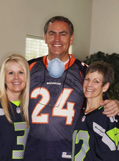 Dr. Harder smiling with two Moses Lake team members