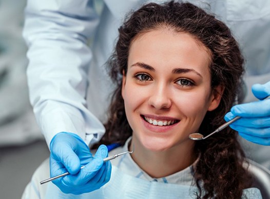 young woman smiling in the dental chair 