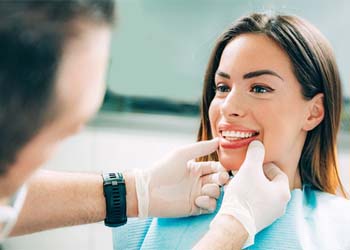 Cosmetic dentist in Moses Lake looking at patient's smile