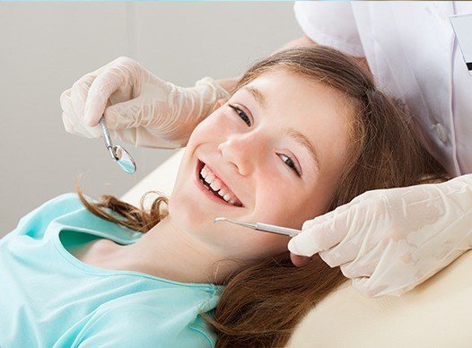 young girl having dental cleaning