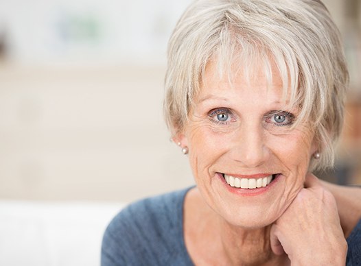 Woman with dental bridge smiling. 