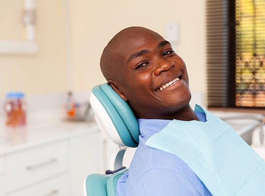 smiling patient who got answers to questions about dental bridges in Moses Lake