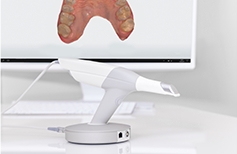 Intraoral camera with digital images of teeth on computer screen