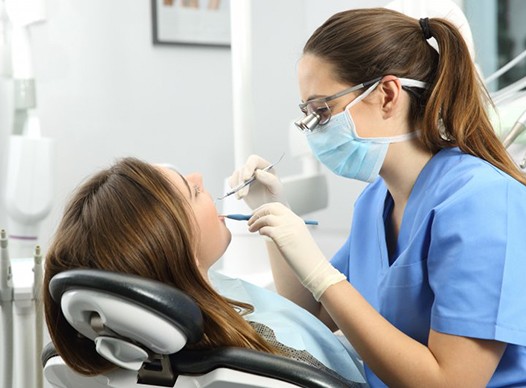 dentist examining patient’s mouth 