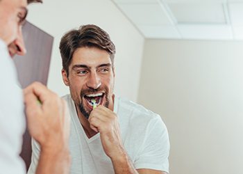 man brushing teeth in Moses Lake