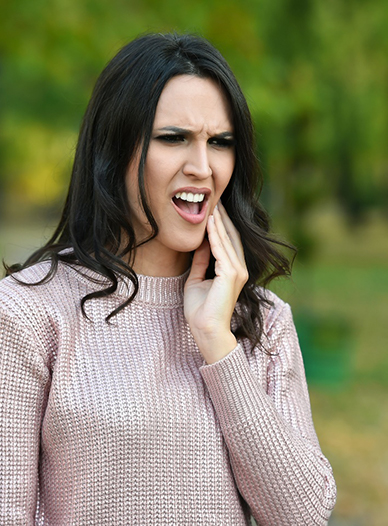 Woman outside with a toothache in Moses Lake