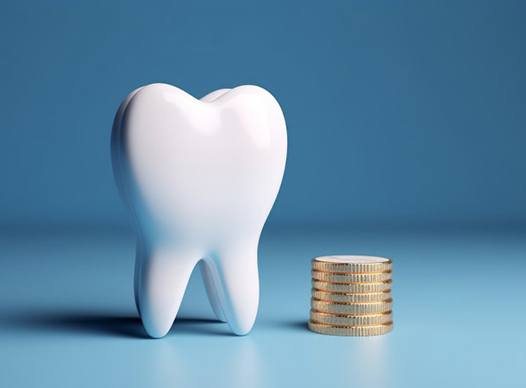 a tooth sitting next to a stack of coins