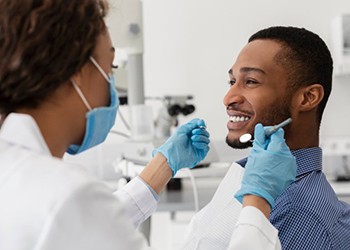 a patient smiling while getting his teeth checked