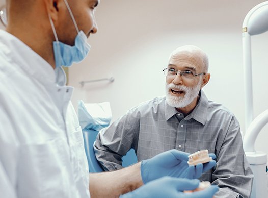 patient learning how to take care of his dental implants in Moses Lake 