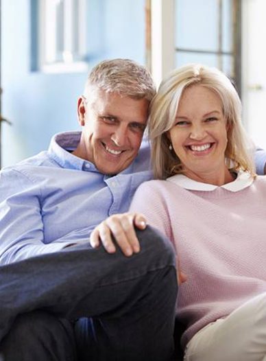 older couple smiling with dental implants in Moses Lake