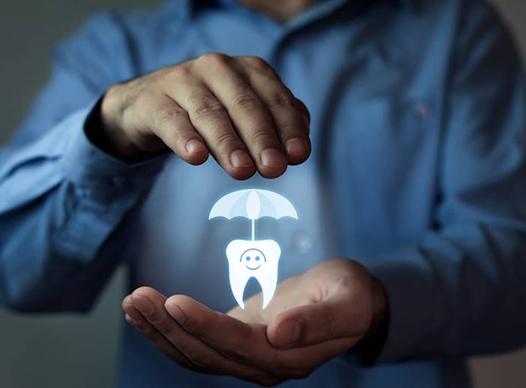 person holding a hologram of a tooth in their hands