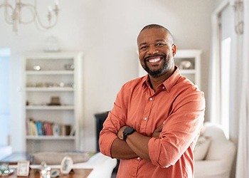 happy man standing in his living room