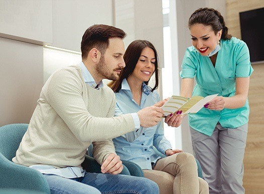 team member showing couple paperwork