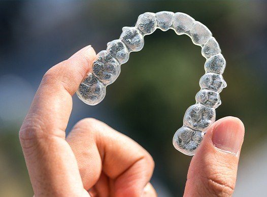 hand holding invisalign