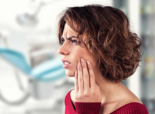 woman in red sweater in pain