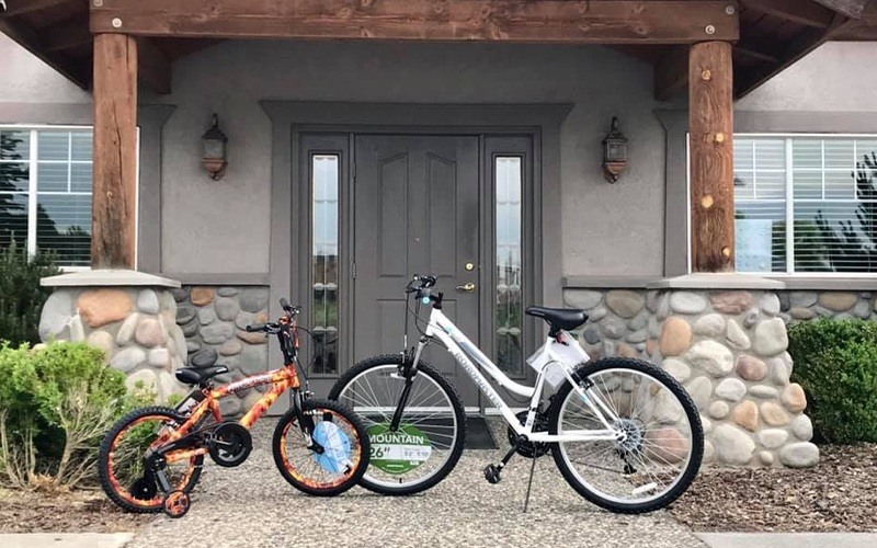 adult and child bike in front of Moses Lake Family Dentistry