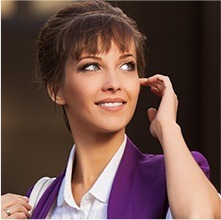 Woman with her hair tied up smiling