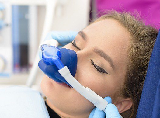 woman sedated with nitrous oxide mask on