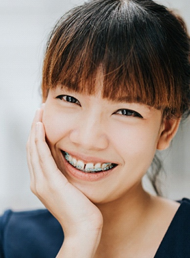 Woman with traditional braces in Moses Lake smiling