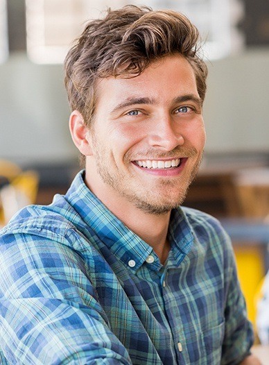 handsome man in plaid shirt smiling