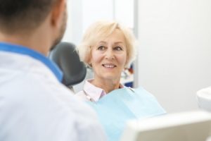 Older woman smiling at dentist