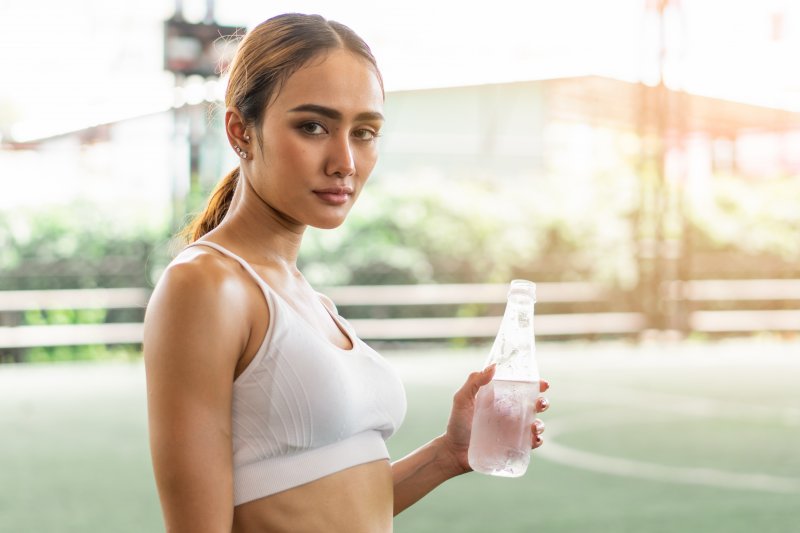 Dehydrated woman holding water bottle