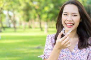 Woman holding her Invisalign aligner.