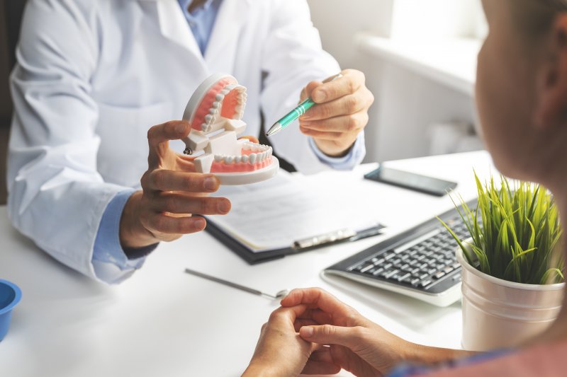 A dentist explaining full mouth reconstruction to a patient